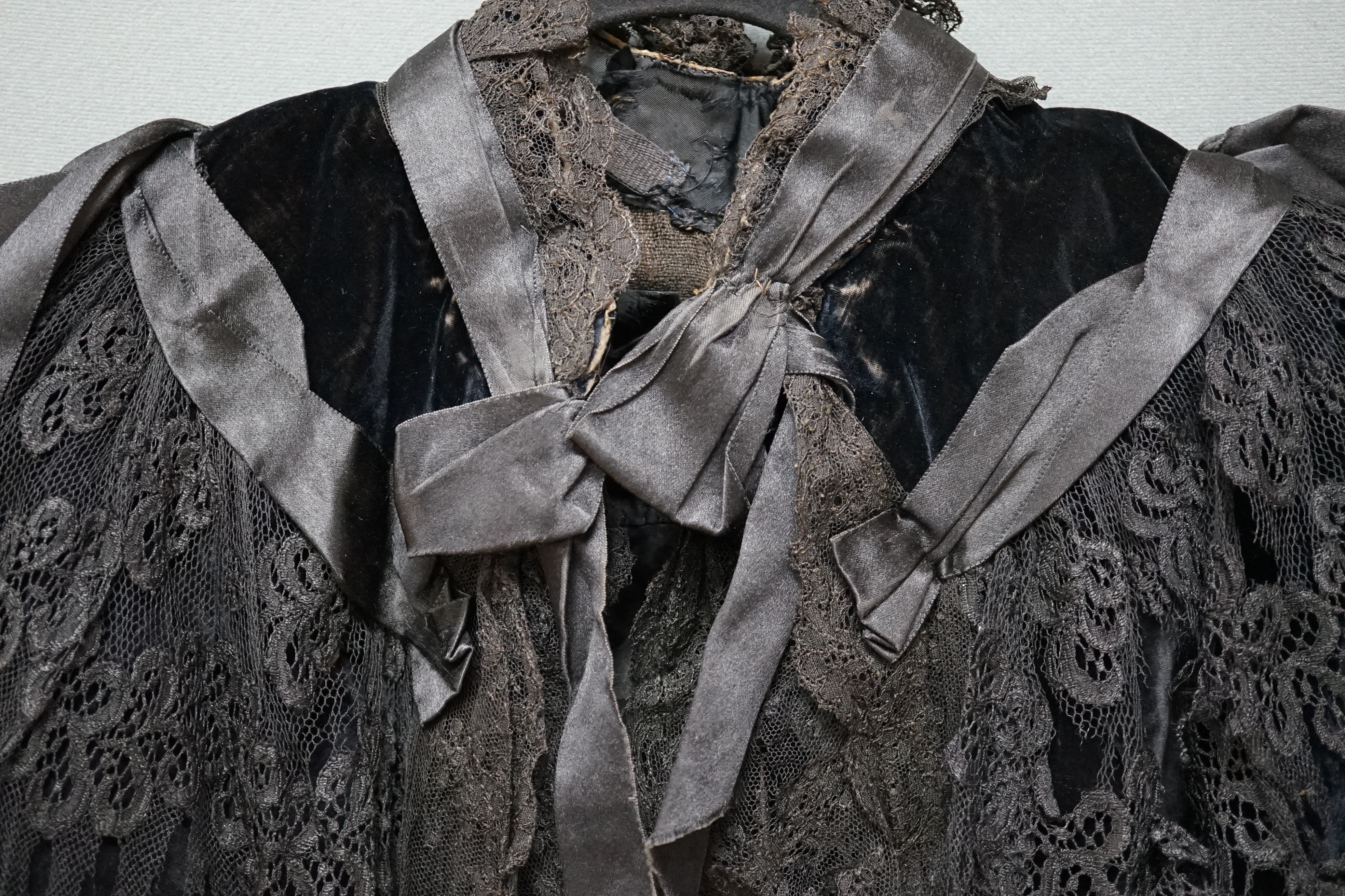 An Edwardian black velvet and black lace evening cape together with a purple chiffon and cream lined blouse labelled John Barker and Co, blouse specialists, Kensington, cape back, neck to bottom edge 72cm. Condition - th